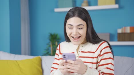 Young-woman-with-braces-happy-looking-at-phone.